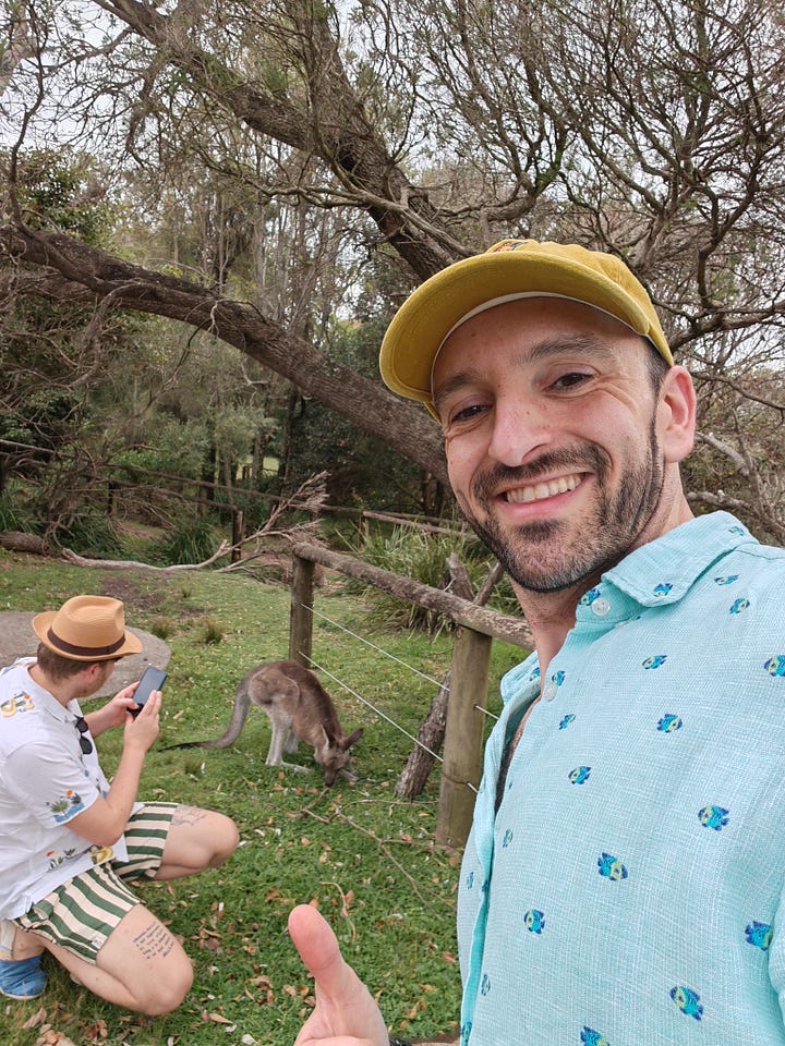 L: a kangaroo and her joey by a puddle of water in nature. 2. Me taking a selfie as my husband photographs a kangaroo in the wild.