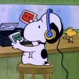 This may contain: a cartoon dog with headphones on sitting at a desk