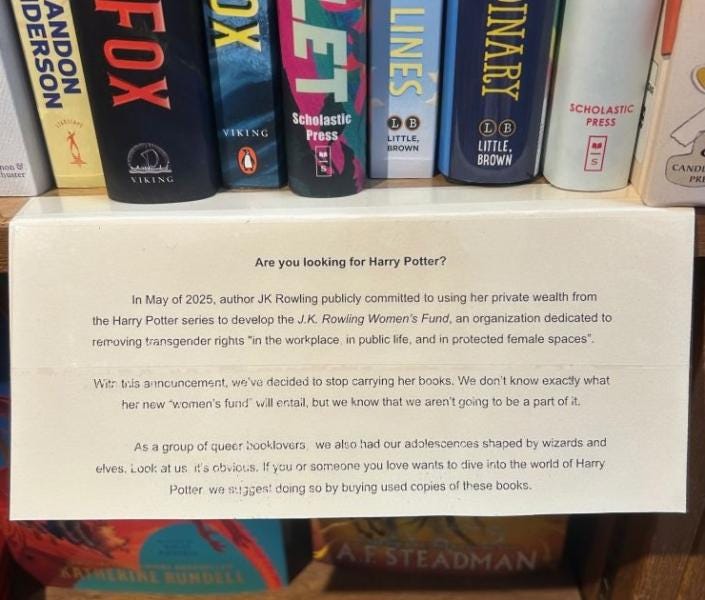 a card taped to a shelf explaining our decision to stop carrying JK Rowling's books due to her ongoing bigotry and persecution of trans people.