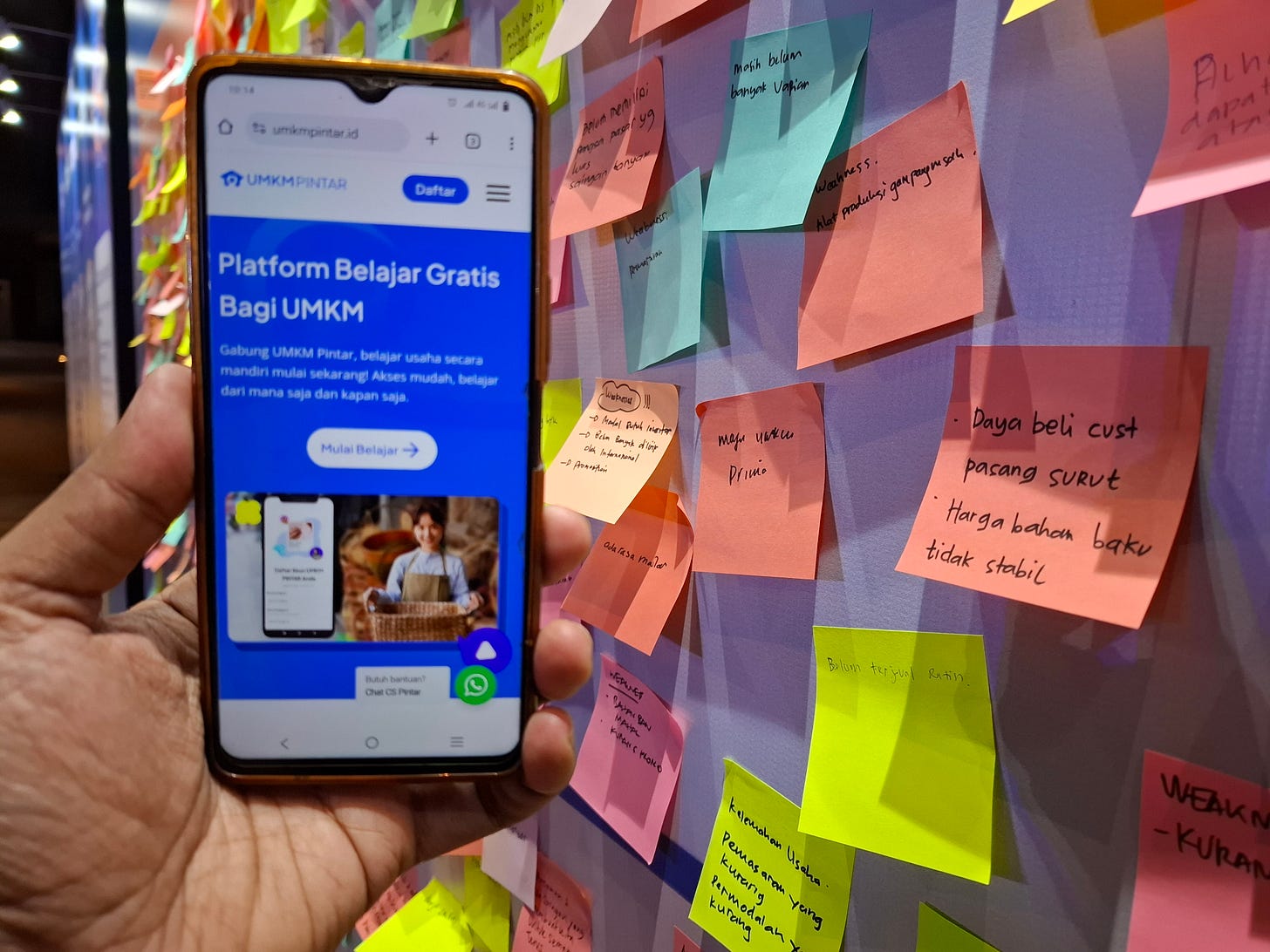 Women MSME owners participating in the UMKM Pintar launch event in Jakarta, with financial training booths and digital learning materials displayed.