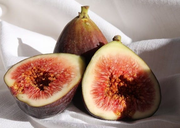 brown and green fruit on white textile