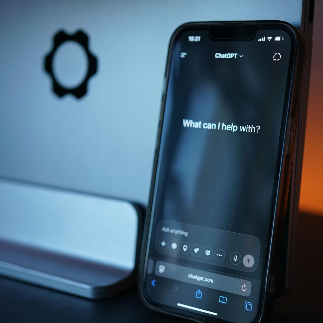 A photo of a phone with the screen opening to an AI chatbot and asking 'what can I help with today?'