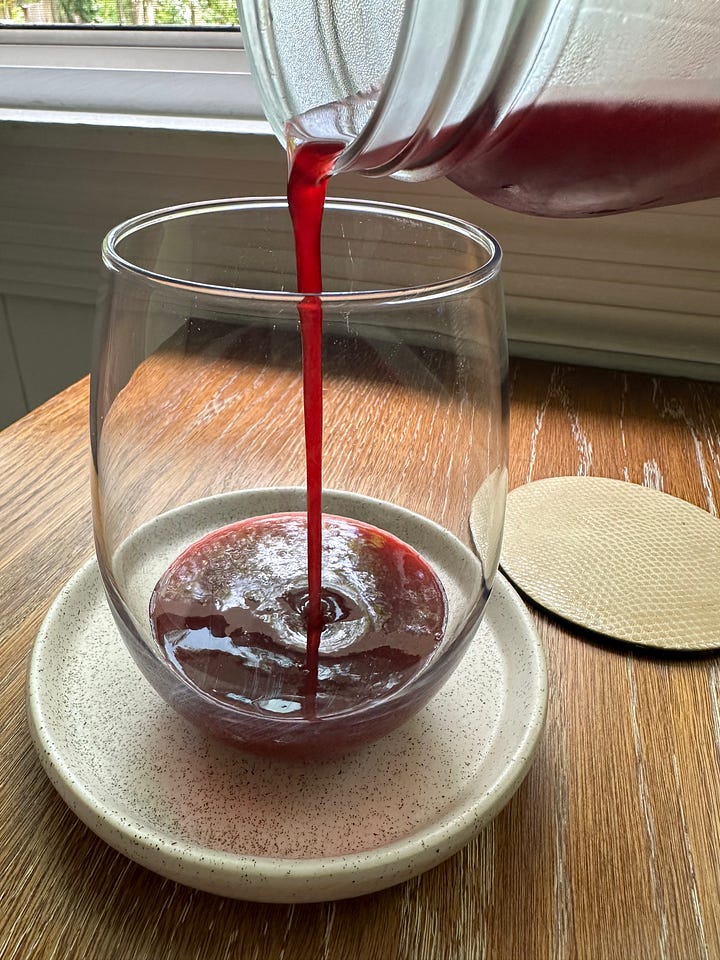 blackberry simple syrup pouring into glass and soda on the right when mixed with seltzer water