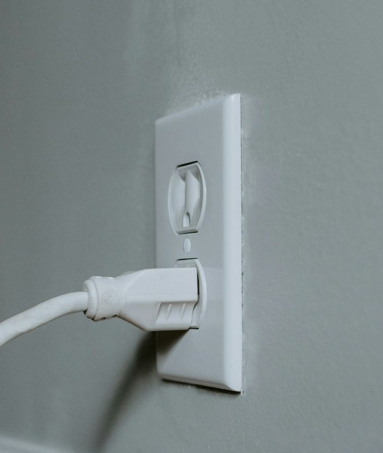 white usb cable plugged in white electric socket white usb cable plugged in white electric socket