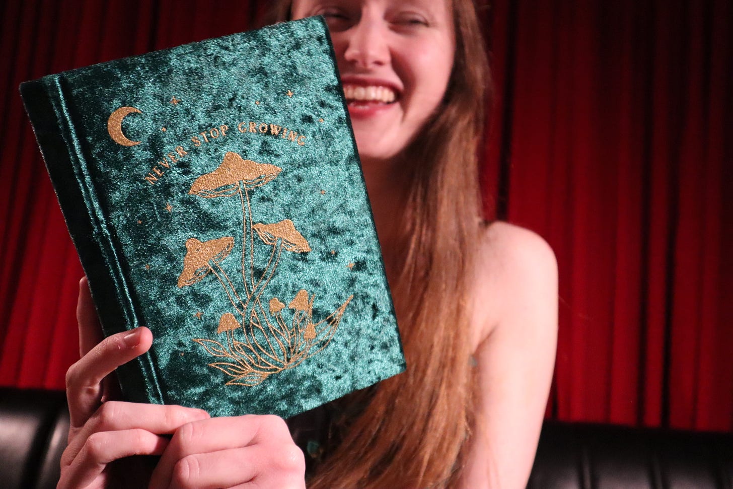 Me with a book that says "Never Stop Growing"
