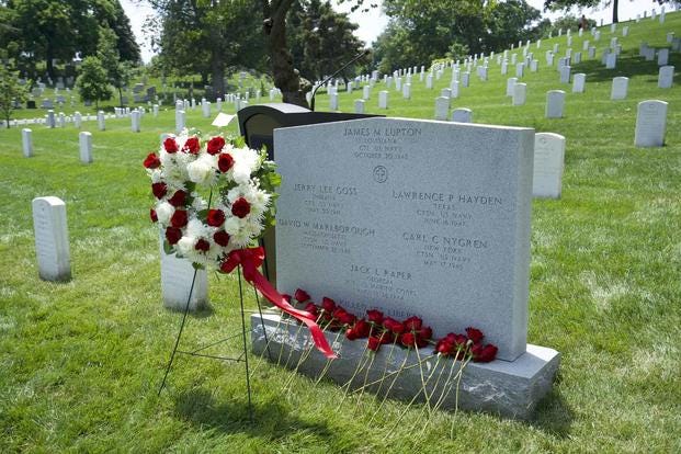 Thirty-four roses are placed on the USS Liberty memorial at Arlington National Cemetery, Section 34 in honor of each sailor killed on June 8, 1967, though some survivors and family members took a rose to remember the day. (Military.com photo by Drew F. Lawrence) Thirty-four roses are placed on the USS Liberty memorial at Arlington.