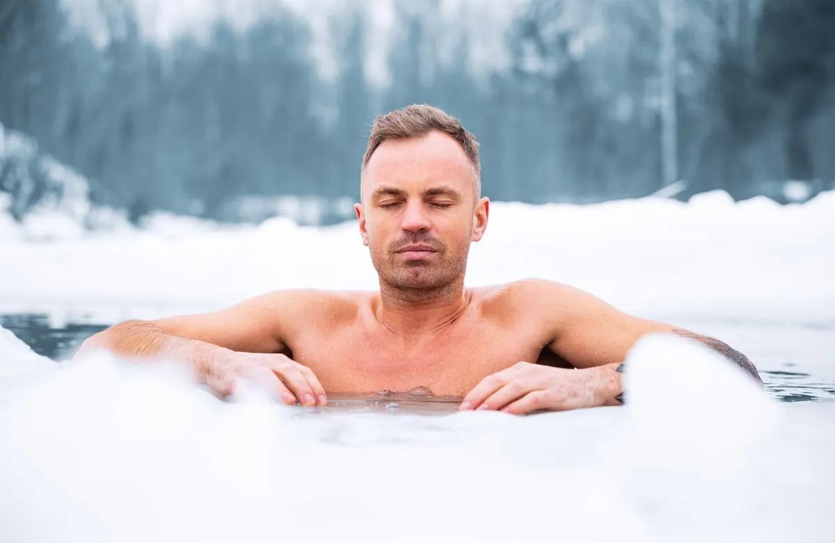 Man relaxing with eyes closed in frigid water in winter Man relaxing with eyes closed in frigid water in winter