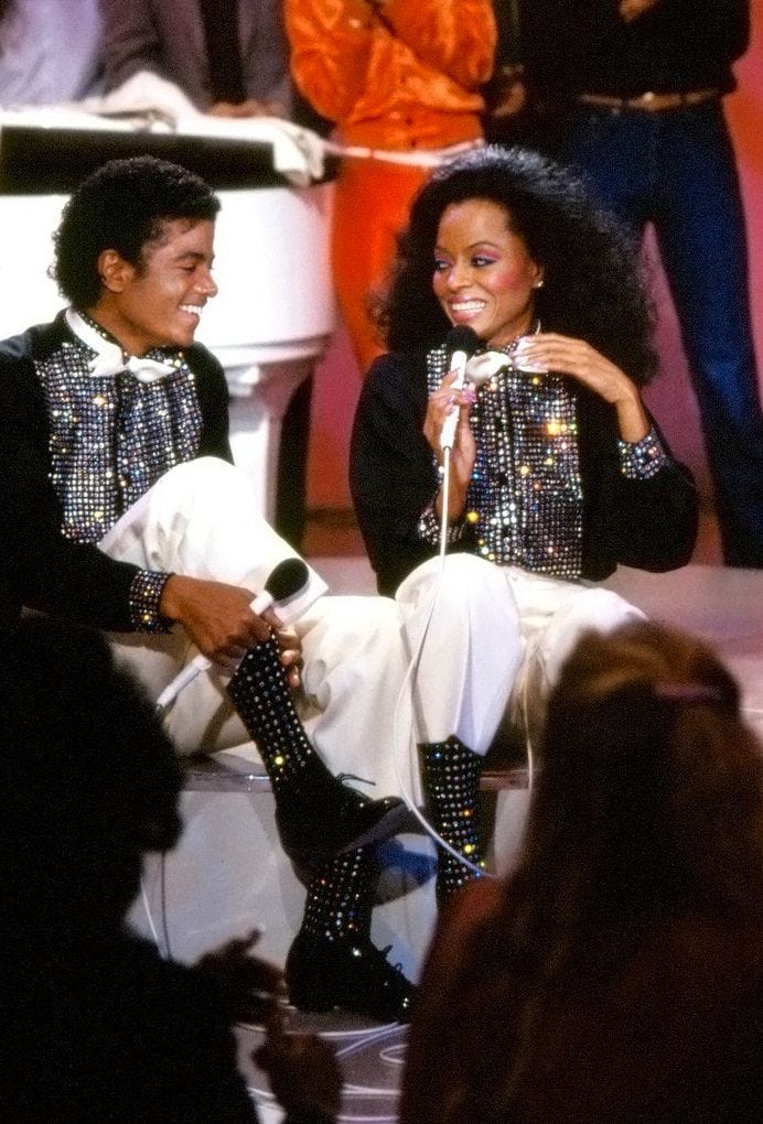 This may contain: a man and woman sitting next to each other on stage This may contain: a man and woman sitting next to each other on stage