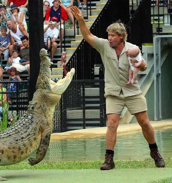 As it is his birthday, Steve Irwin feeding croc whilst holding a baby. :  r/UtterlyUniquePhotos