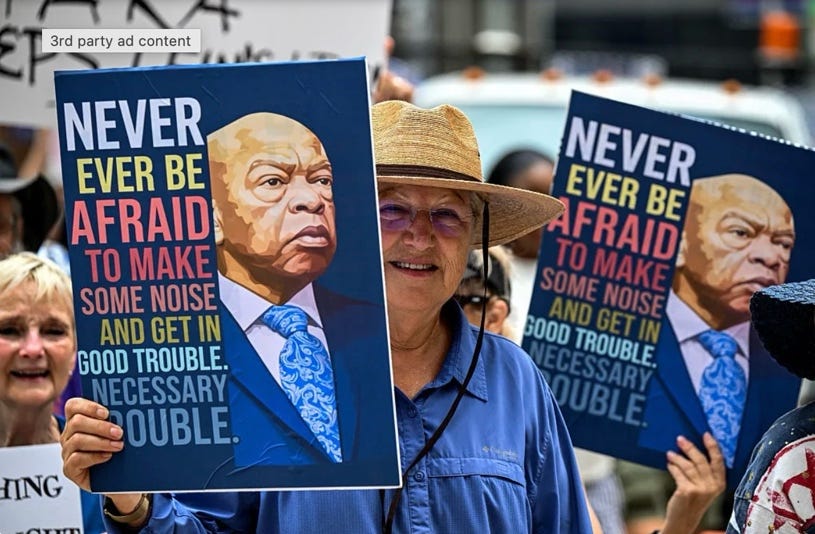 A person holding signs in a parade

AI-generated content may be incorrect.