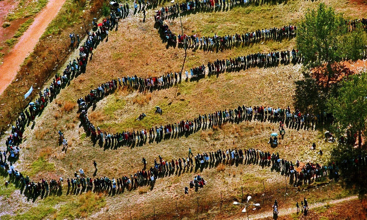 South Africans queue to vote in the first universal-suffrage election, April 1994