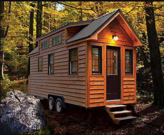 A small wooden cabin in the woods

Description automatically generated with medium confidence