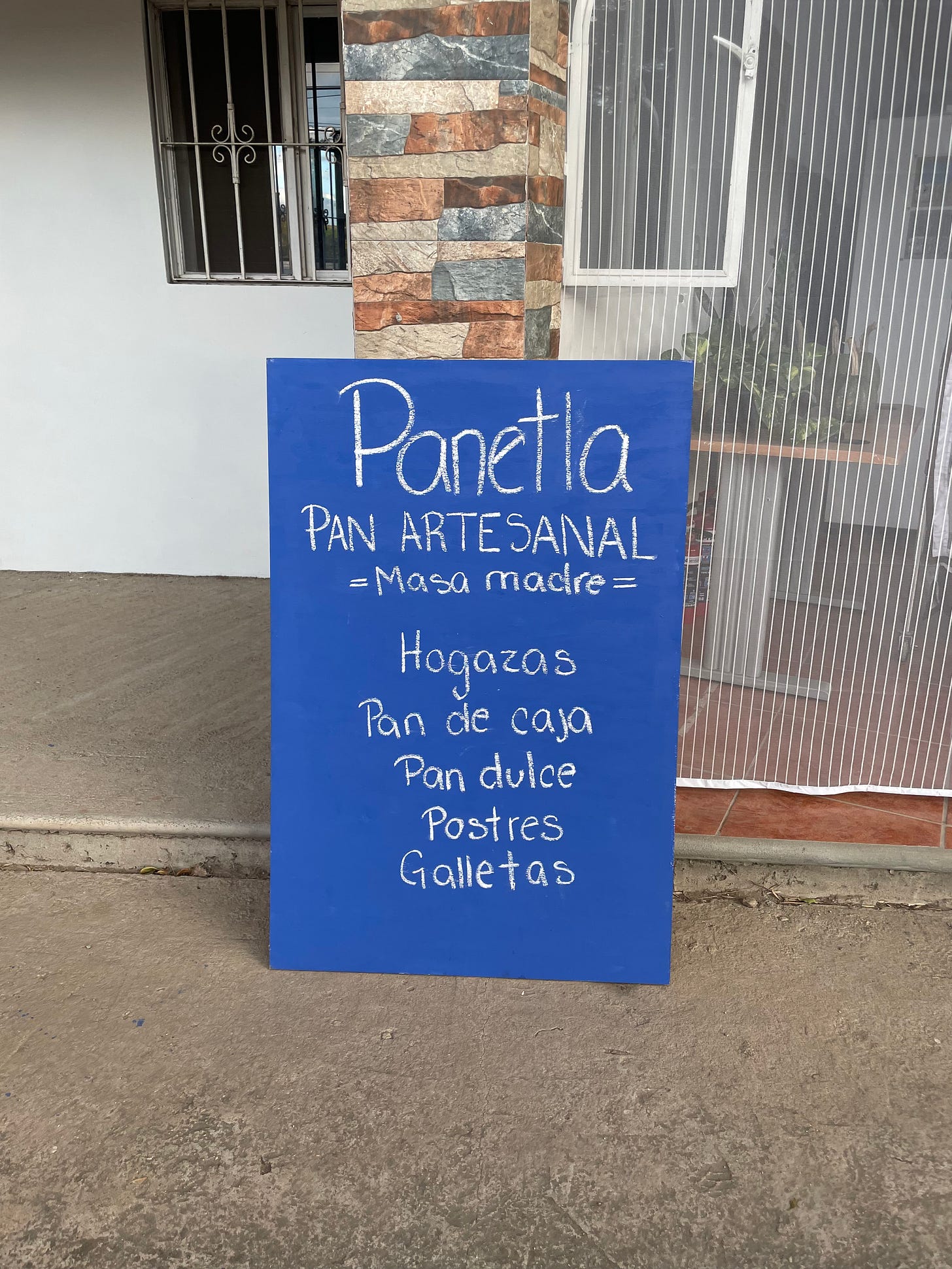 The blue sign advertising the Panetla bakery.