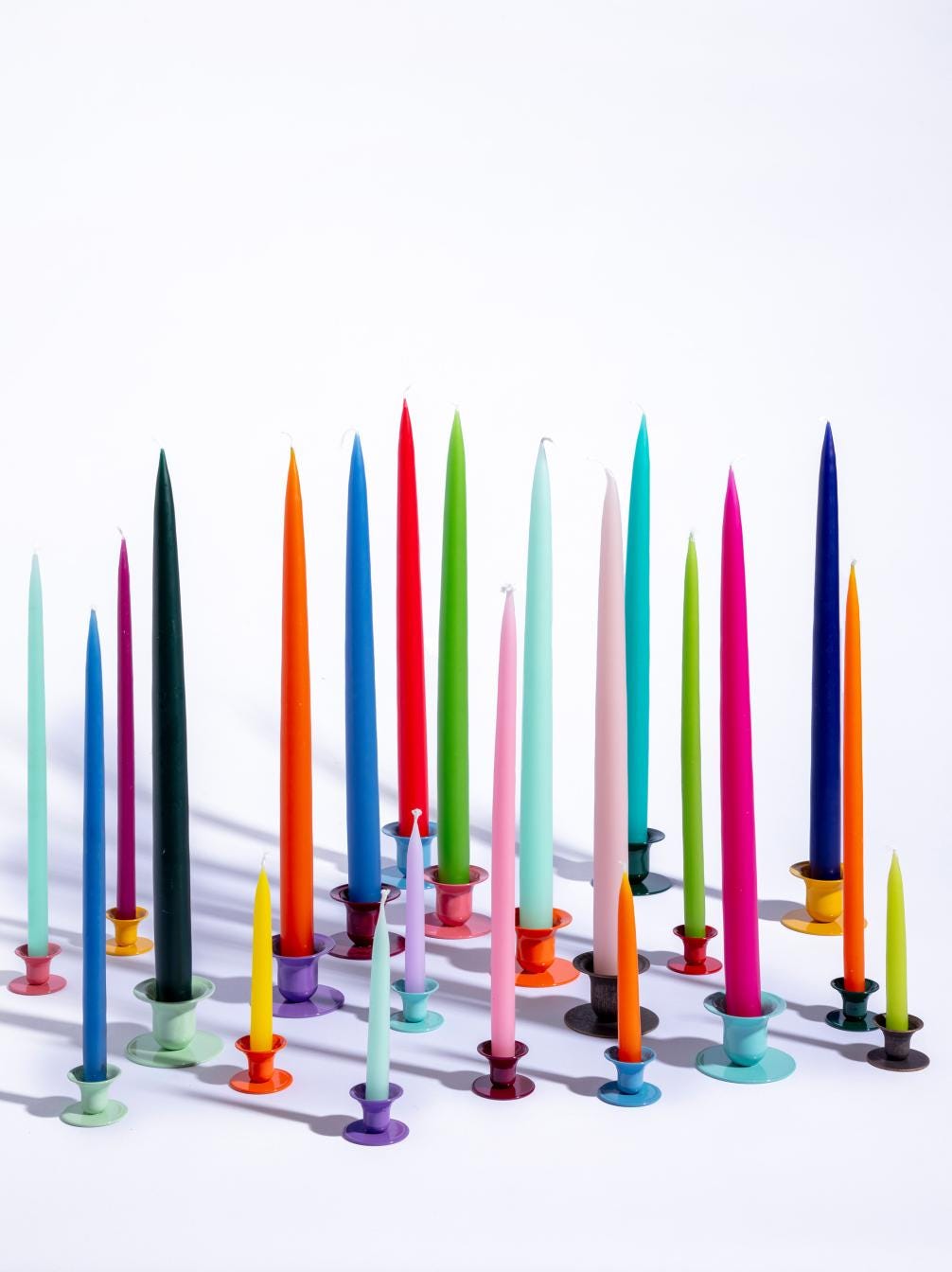 Coloured tapers and holders in mismatched colours