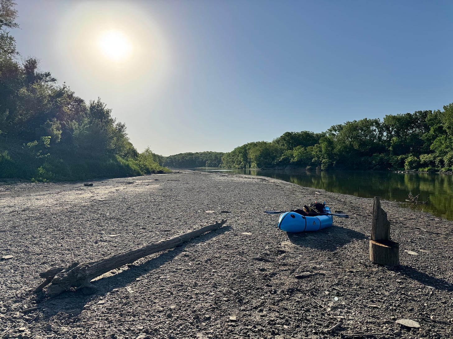 Packraft on riverbank at sunrise