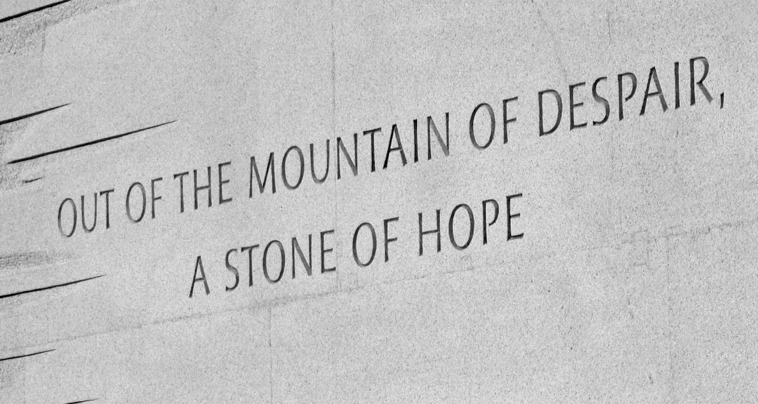 Words inscribed on a textured stone wall Words inscribed on a textured stone wall