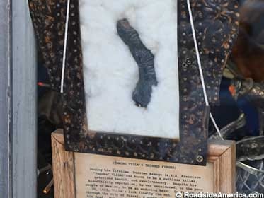 Blackened finger, mummified as if about to pull a trigger. Blackened finger, mummified as if about to pull a trigger.