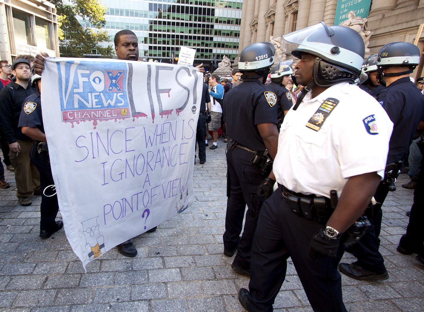 Policeman walks by protester holding sign that reads 'Fox News Lies' on the 1yr anniversary of the Occupy Wall St protests on September 17, 2012 in New York City CREDIT Glynnis Jones Shutterstock.jpg (2000×1472) Policeman walks by protester holding sign that reads 'Fox News Lies' on the 1yr anniversary of the Occupy Wall St protests on September 17, 2012 in New York City CREDIT Glynnis Jones Shutterstock.jpg (2000×1472)