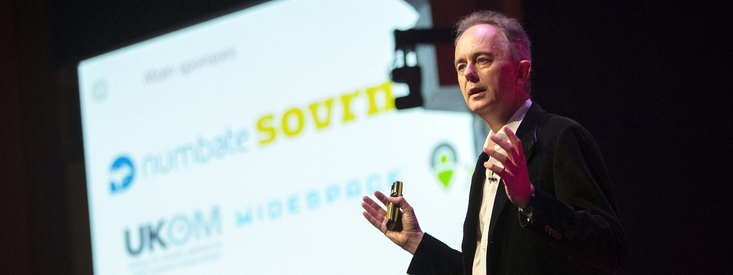 Adam Morgan speaking on stage