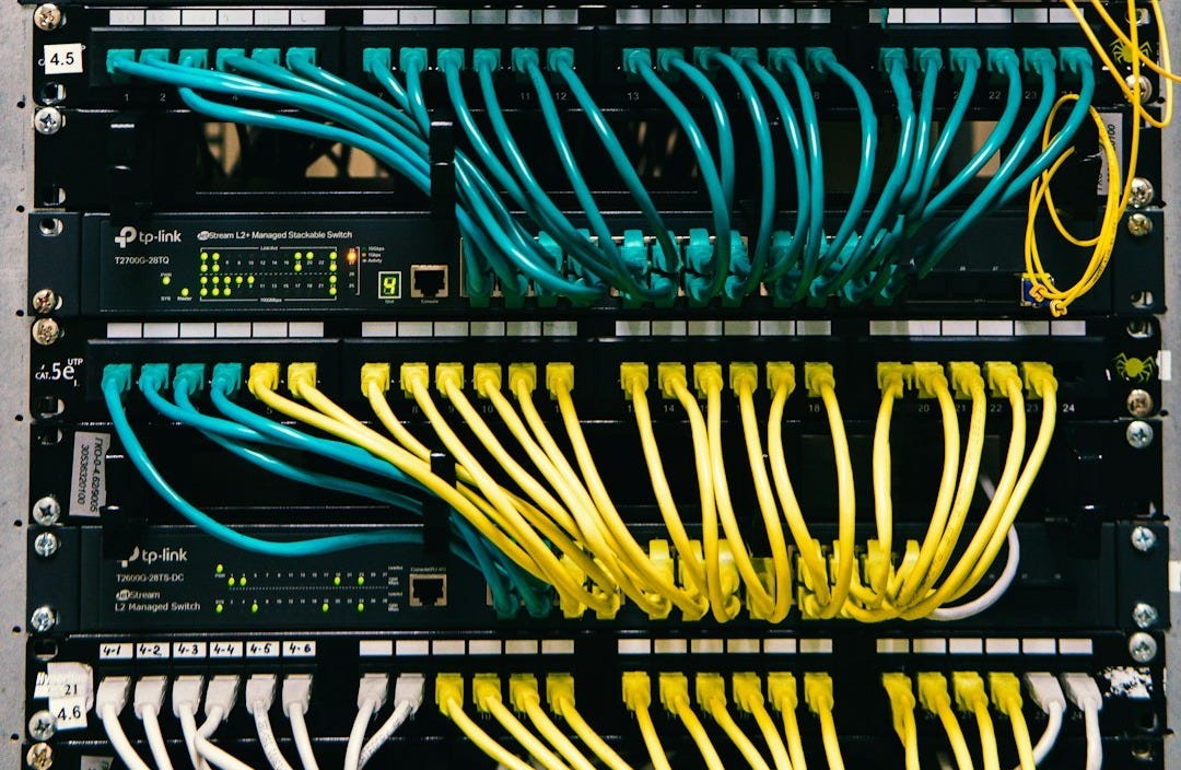 a rack of servers with wires and wires attached to them a rack of servers with wires and wires attached to them