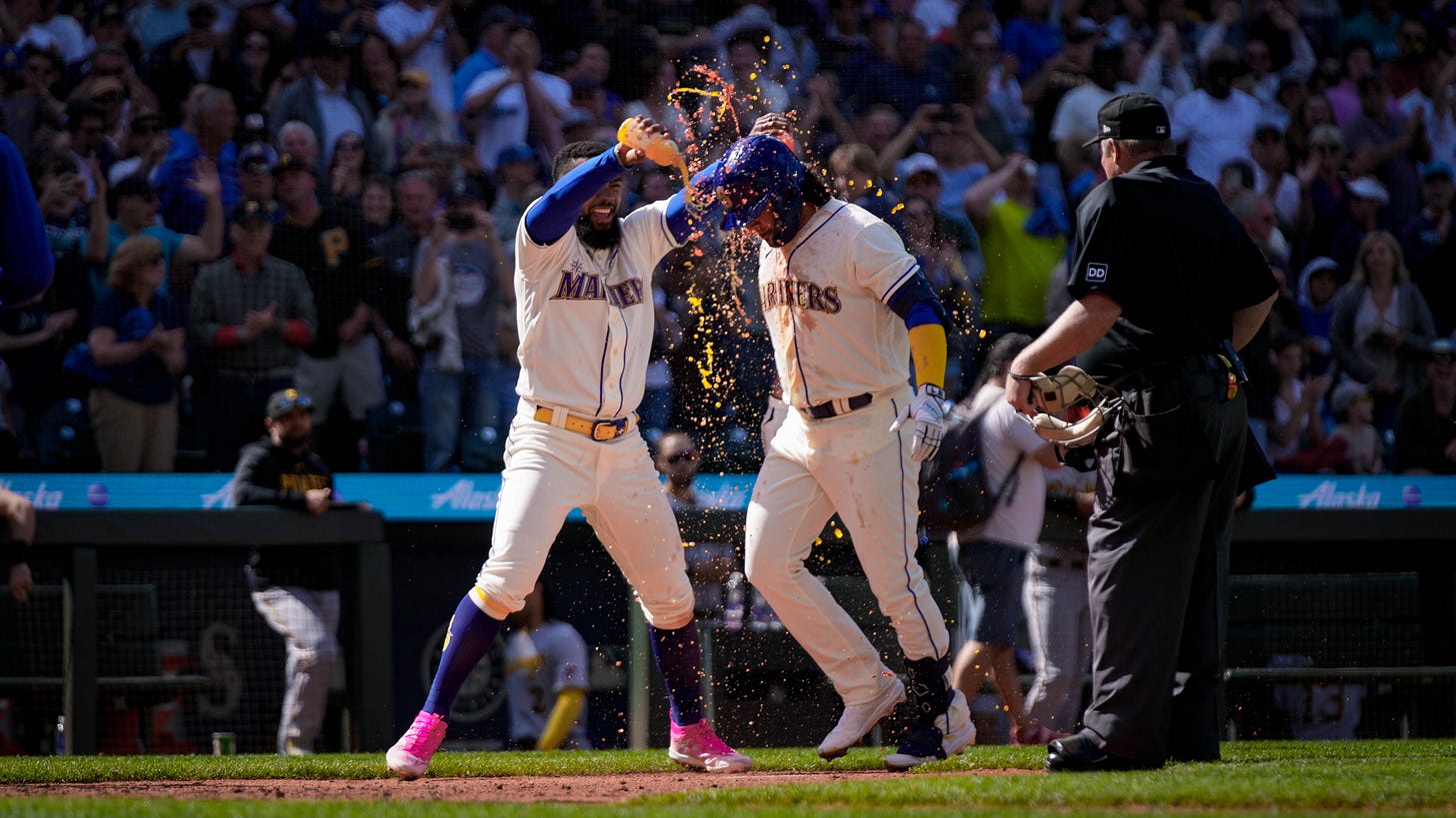 Teoscar dumps orange Gatorade on Geno as he nears home plate. 