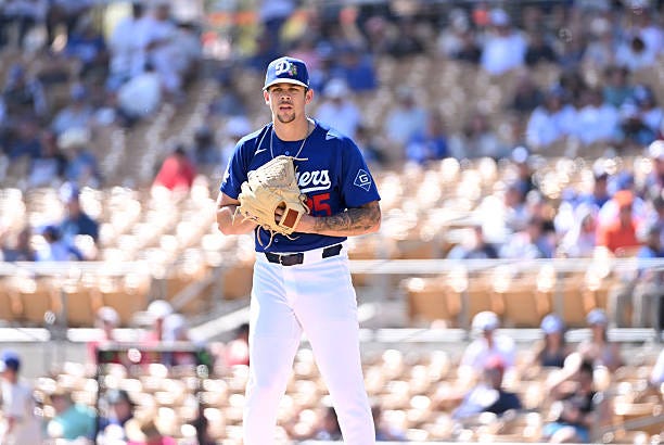 Gavin Stone of the Los Angeles Dodgers delivers a pitch against the Cleveland Guardians during a spring training game at Camelback Ranch on February...