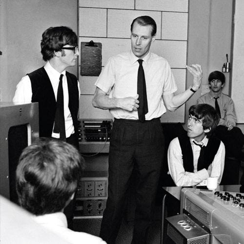 This may contain: black and white photograph of men in office setting with one man pointing at the camera