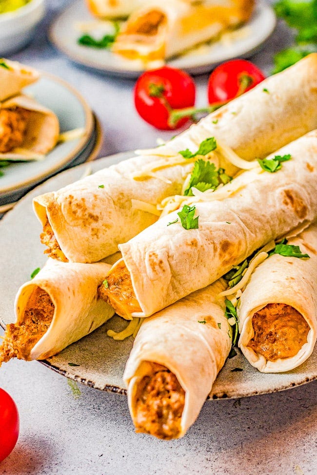 Baked Cheesy Beef Taquitos - Craving Mexican food? Make these EASY taquitos made with seasoned ground beef, melted cheese, cream cheese, sour cream, salsa, and baked to crispy perfection! Family friendly, picky-eater approved, and PERFECT for busy weeknight dinners, game day events or parties! 