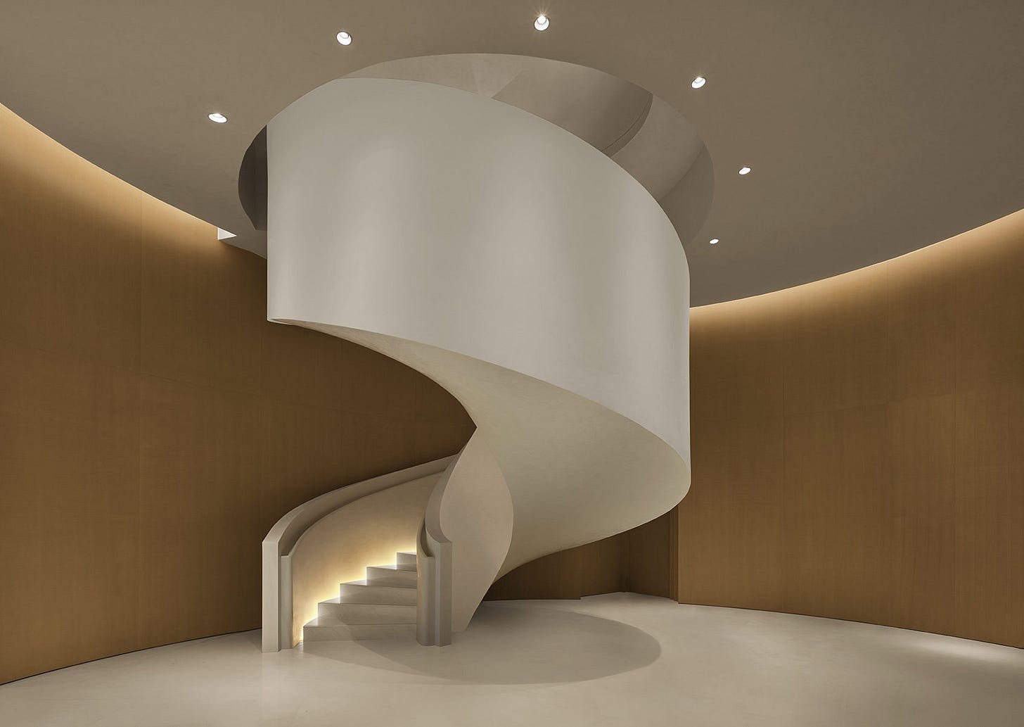 Sculptural white spiral staircase at The Singapore EDITION, enclosed by softly curved walls and warm indirect lighting Sculptural white spiral staircase at The Singapore EDITION, enclosed by softly curved walls and warm indirect lighting