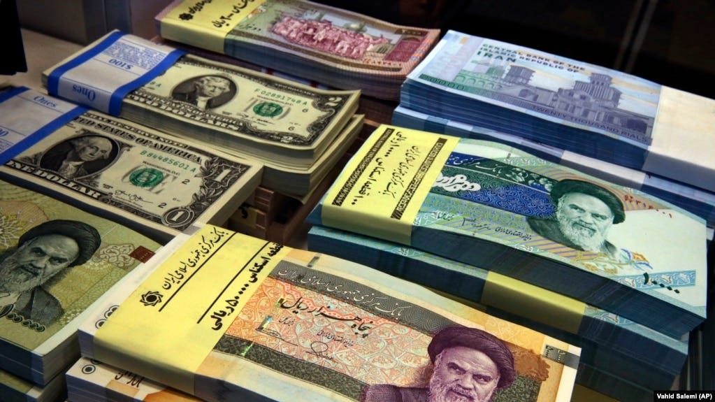 Iranian and U.S. banknotes are on display at a currency exchange shop in downtown Tehran, FILE PHOTO Iranian and U.S. banknotes are on display at a currency exchange shop in downtown Tehran, FILE PHOTO