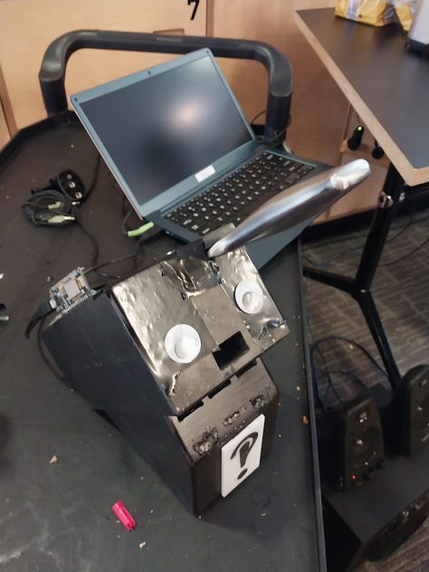 A toaster and microwave with microphones, and a knife block with googly eyes and a 'mouth' open for screaming