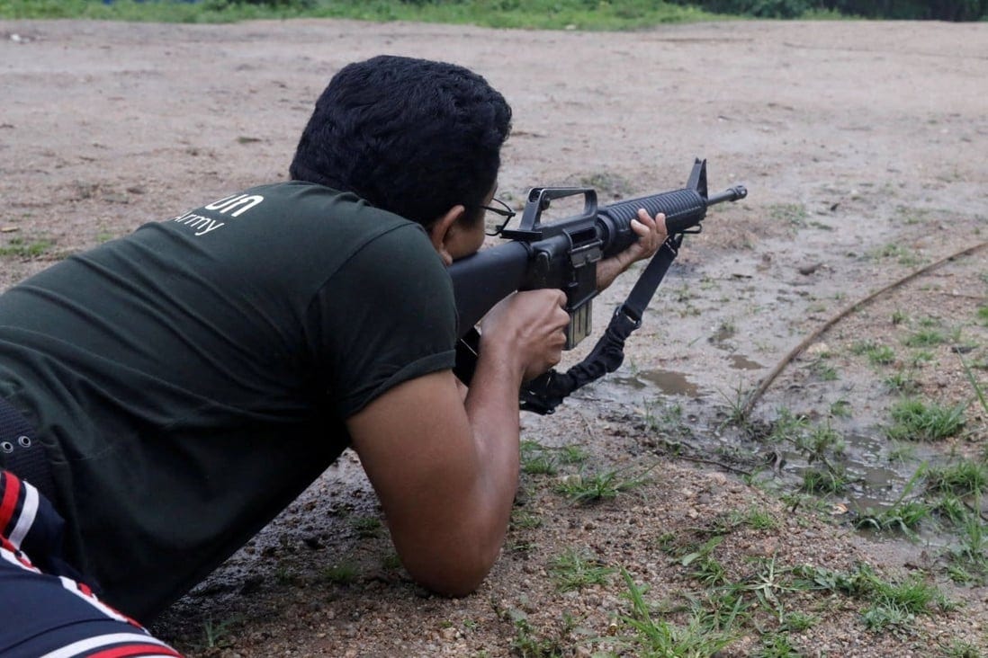 Sithu Maung, an elected member of parliament in the 2020 election, aims a gun at a training camp in an area controlled by ethnic Karen rebels, Karen State, Myanmar. Photo: Reuters/File Sithu Maung, an elected member of parliament in the 2020 election, aims a gun at a training camp in an area controlled by ethnic Karen rebels, Karen State, Myanmar. Photo: Reuters/File
