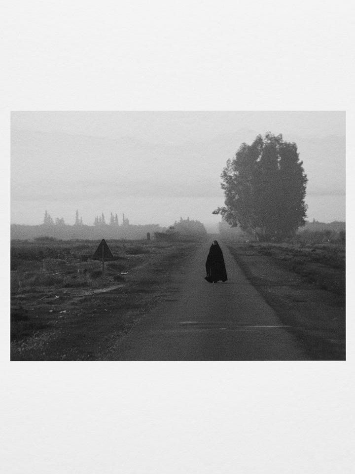 Two black-and-white stills from Shirin Neshat’s Fervor showing a man and a woman walking alone on separate roads, emphasizing distance, restraint, and tension.