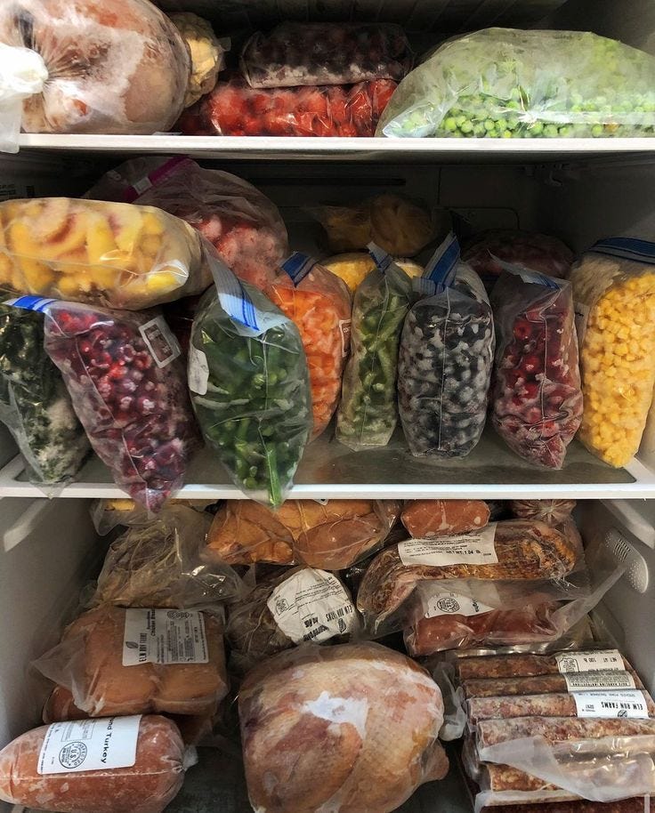 This may contain: an open refrigerator filled with lots of different types of vegetables and meat in plastic bags