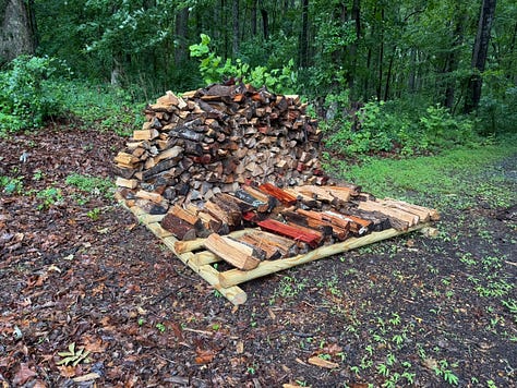 Three side-by-side photos showing storm-damaged oak trees and the resulting firewood. The left photo shows a large oak tree that fell across a driveway, blocking the path. The center photo shows another fallen oak tree on the opposite side of the driveway, with branches and trunk sections that need to be cut up. The right photo shows a pile of cut and split wood stacked on pallets near the edge of the woods after cleanup began.