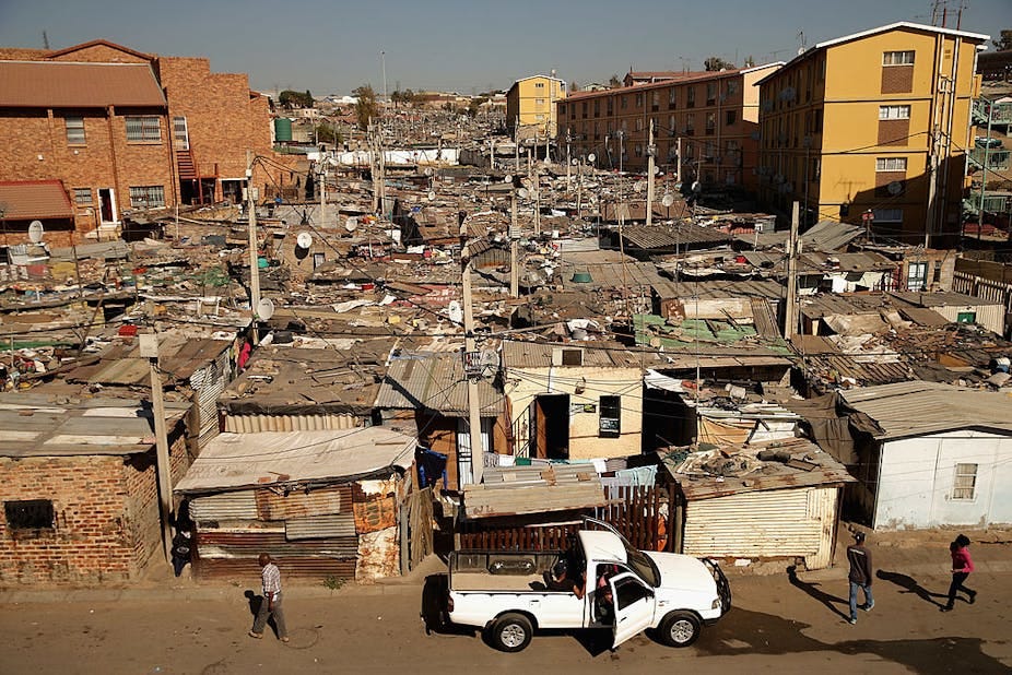 Crowded urban landscape of shacks and multiple storey buildings. Crowded urban landscape of shacks and multiple storey buildings.