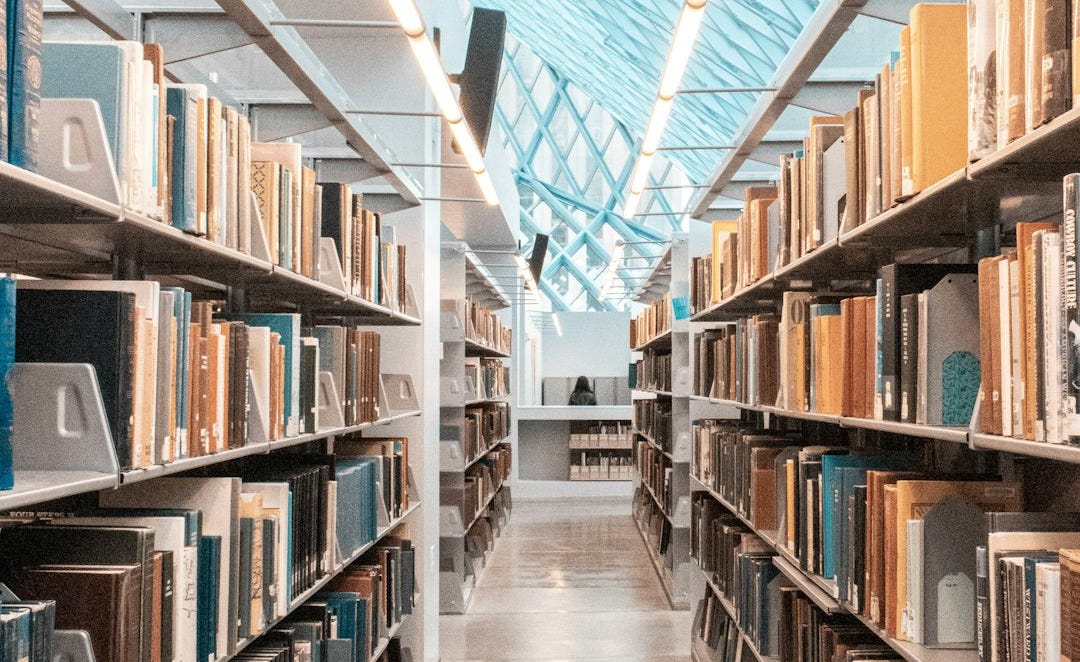 brown wooden book shelves in library