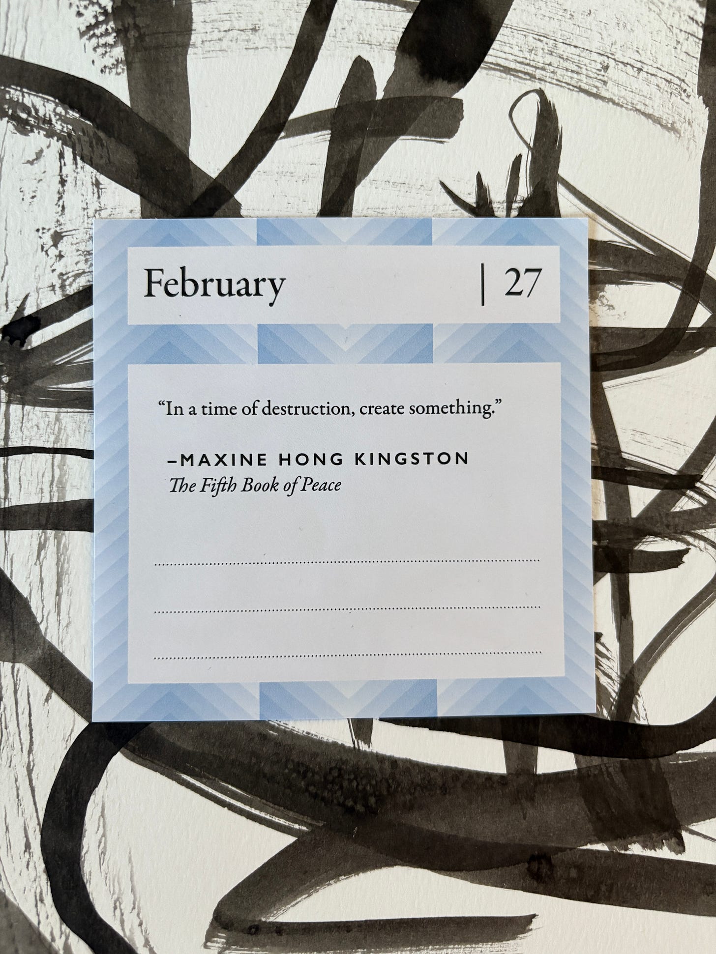 A quote calendar page from Feb. 27 with a quote from Maxine Hong Kingston's "The Fifth Book of Peace" on an abstract ink drawing. "In a time of destruction, create something."