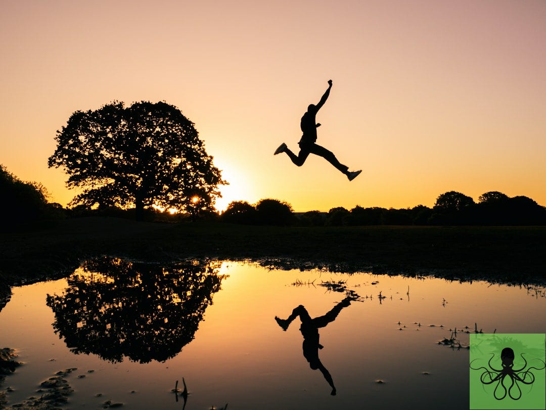 silhouette photo of man jumping on body of water during golden hour