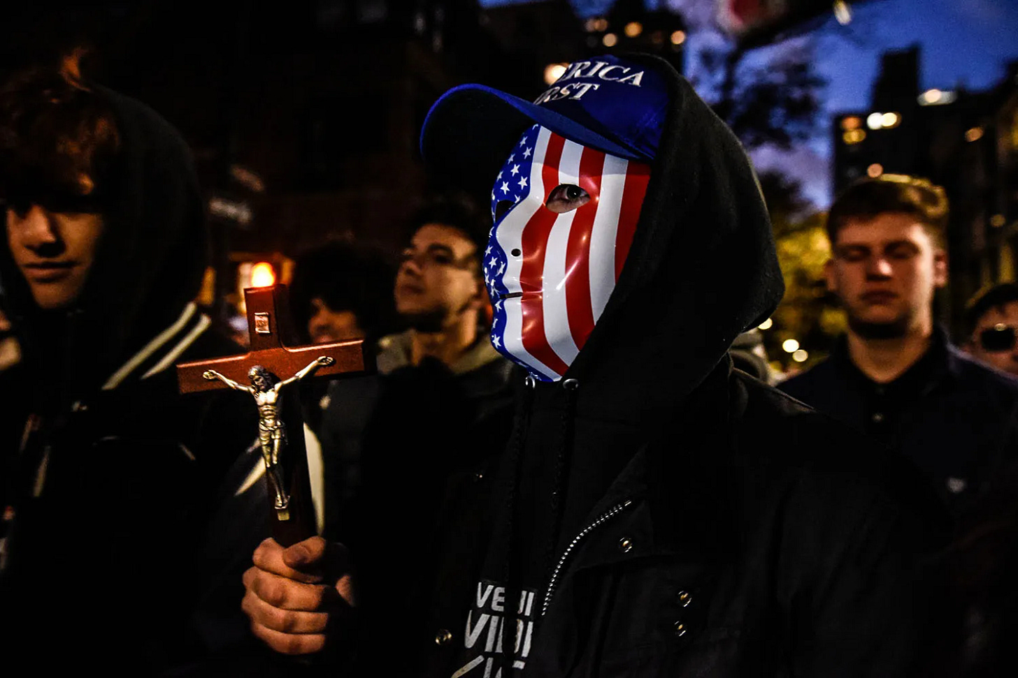 People associated with the far-right group America First attend an anti-vaccine protest in New York. People associated with the far-right group America First attend an anti-vaccine protest in New York.