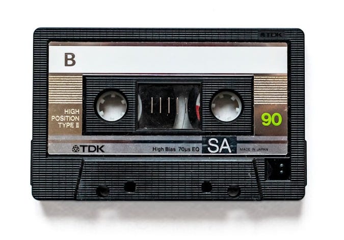 a black and white tape recorder on a white background a black and white tape recorder on a white background