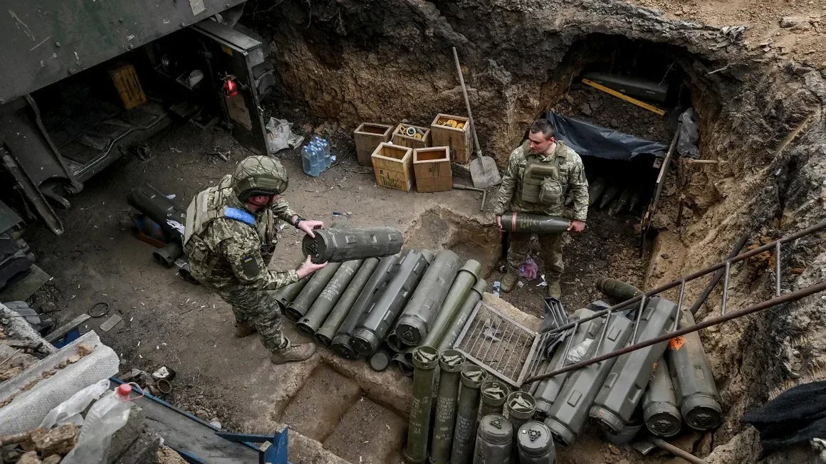 Ukrainian service members prepare shells next to a self-propelled howitzer at a position near a front line in Zaporizhzhia region, Ukraine, on April 3, 2024. Reuters