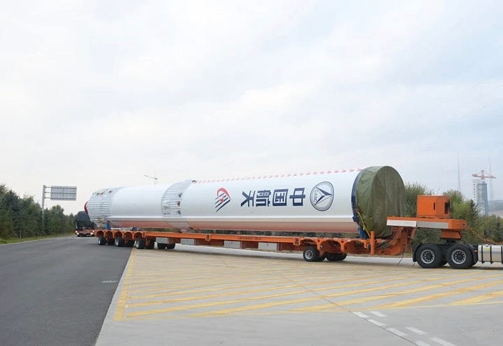 The Long March 6A's first-stage heading to the launch pad (left) and fairing being lifted atop of the launch vehicle (right).