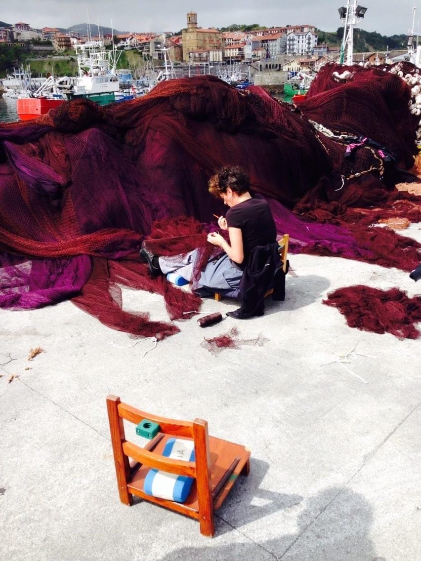 Women mending nets with Getaria and the port in the background. Women mending nets with Getaria and the port in the background.