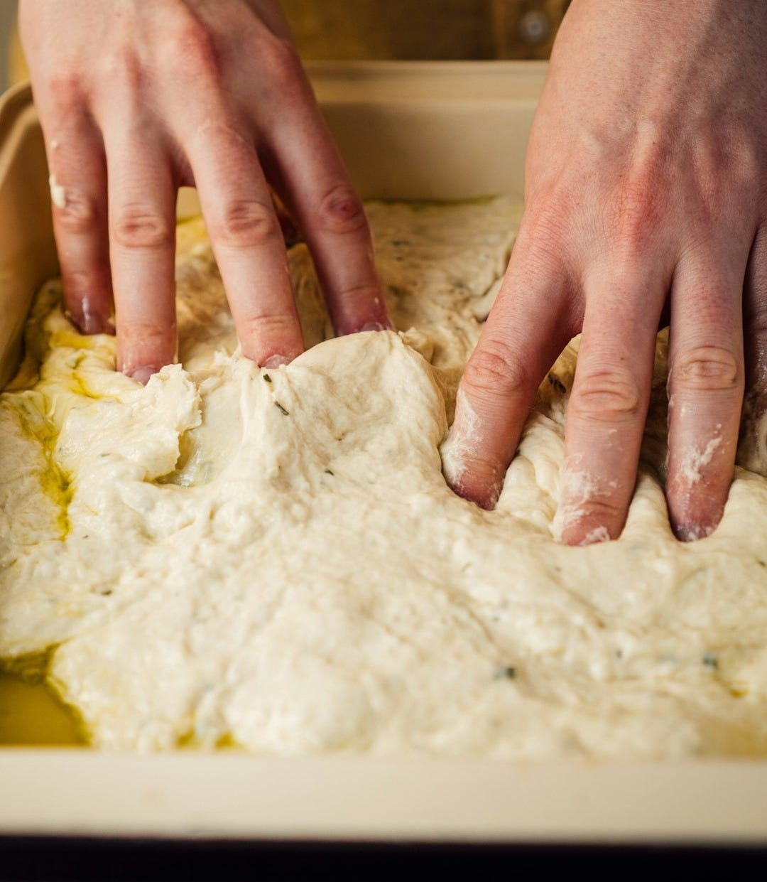 person holding white dough on white table person holding white dough on white table
