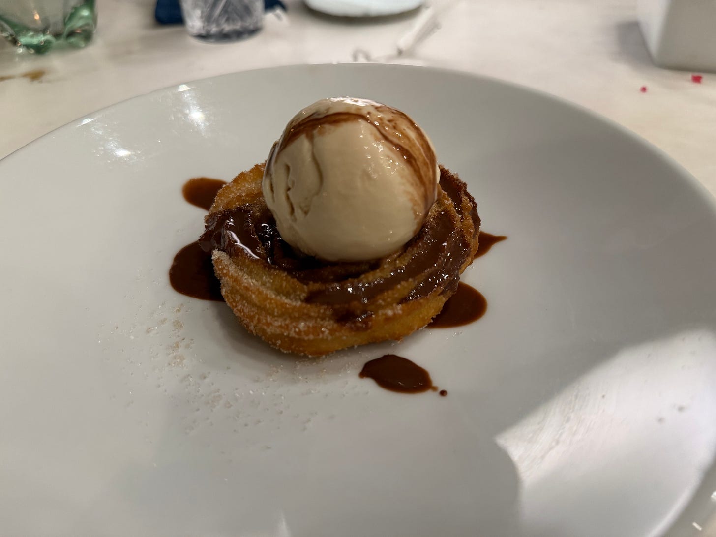 Churro with ice cream and chocolate sauce, one of five nights of dessert in Mexico.