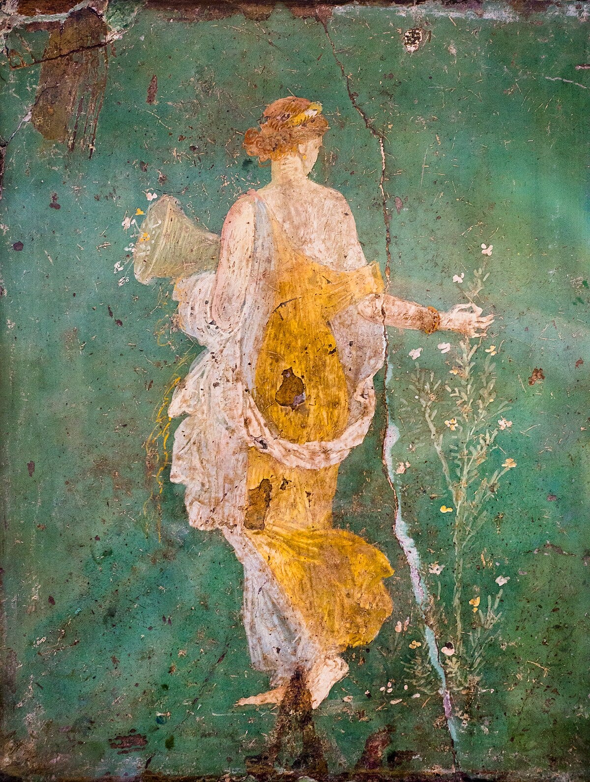 Fresco of Flora: a woman in a yellow dress against a green background, holding a cornucopia and standing next to flowers