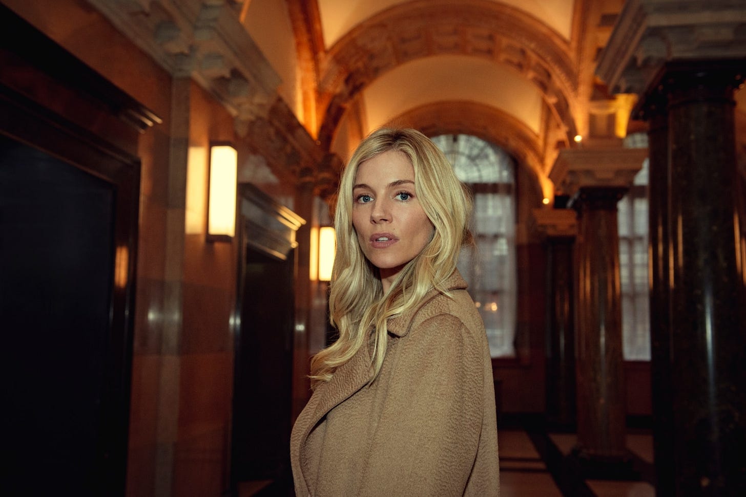 Sienna Miller (and her perfect camel cashmere Max Mara coat) as Sophie Whitehouse in Anatomy of a Scandal.