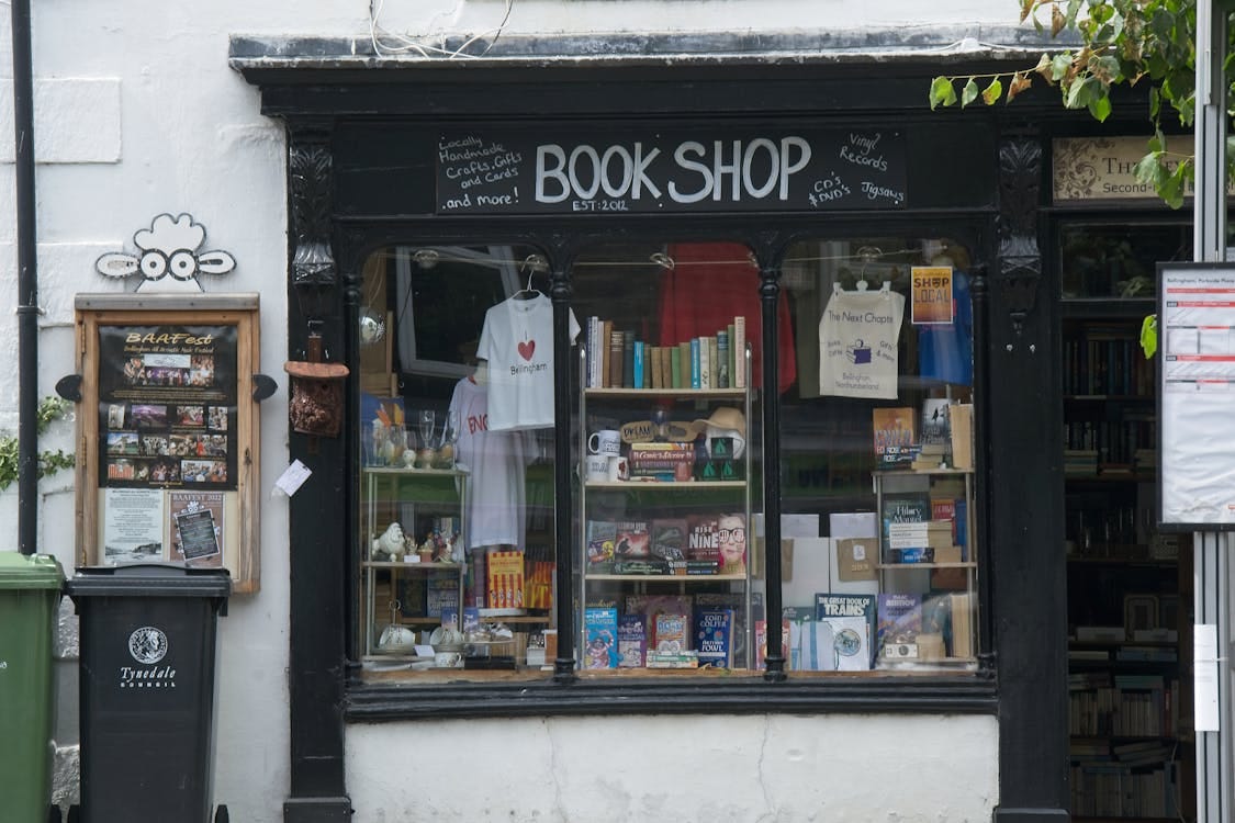 Free Exterior of a quaint bookshop in Bellingham, UK, showcasing a variety of books and gifts. Stock Photo
