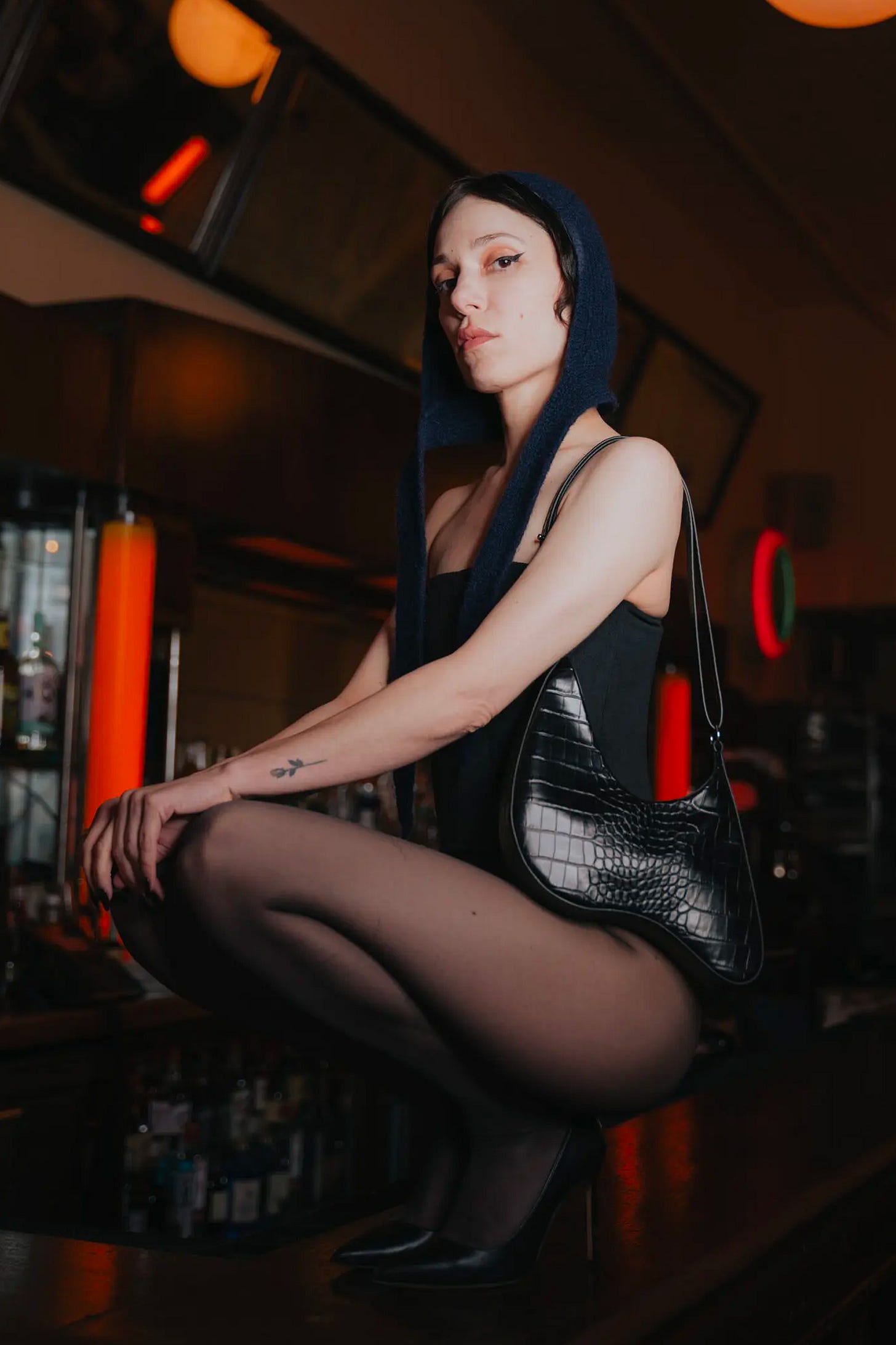 Image from Puppets & Puppets of model wearing their Thing 2 purse in black.